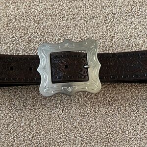 Tooled black leather belt with engraved silver buckle. Polo Jean Co, size M/L